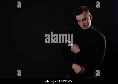young adult man posing on black background. Stock Photo
