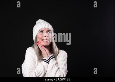 Happy beautiful girl holding her cheeks with a laugh looking to the side. Expressive facial expressions .Cosmetology and Spa Stock Photo