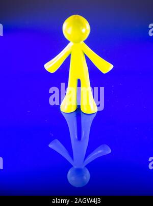 A plastic figure of a man standing tall. Stock Photo