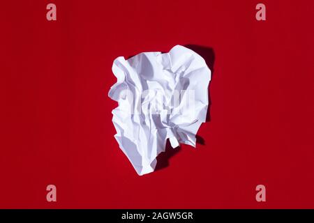 Folded sheet of paper on a red background Stock Photo