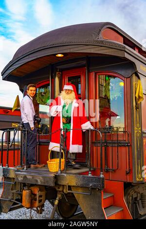Strasburg, USA. 21st Dec, 2019. Santa hops aboard the Strasburg Rail Road for transportation to visit with excited children before Christmas. Credit: George Sheldon/Alamy Live News Stock Photo