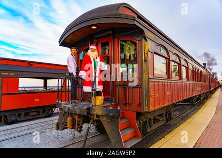 Strasburg, USA. 21st Dec, 2019. Santa hops aboard the Strasburg Rail Road for transportation to visit with excited children before Christmas. Credit: George Sheldon/Alamy Live News Stock Photo