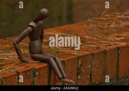 A mannequin depicts a person who is in deep depression and contemplating giving up their life, by suicide. Stock Photo