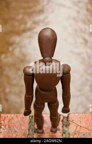 A mannequin depicts a person who is in deep depression and contemplating giving up their life, by suicide. Stock Photo