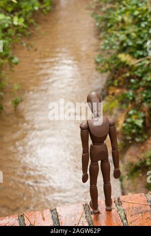 A mannequin depicts a person who is in deep depression and contemplating giving up their life, by suicide. Stock Photo