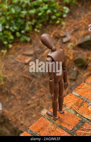 A mannequin depicts a person who is in deep depression and contemplating giving up their life, by suicide. Stock Photo