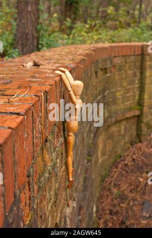 A mannequin depicts a person who is in deep depression and contemplating giving up their life, by suicide. Stock Photo