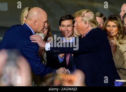 United States President Donald J. Trump congratulates US Space Force General John W. 'Jay' Raymond, Commander of the US Space Force, left, after making remarks and signing S.1790, the National Defense Authorization Act for Fiscal Year 2020 at Joint Base Andrews in Suitland, Maryland on Friday, December 20, 2019. US Secretary of Defense Dr. Mark T. Esper looks on from center. First lady Melania Trump is visible at far right.Credit: Ron Sachs/CNP /MediaPunch Stock Photo