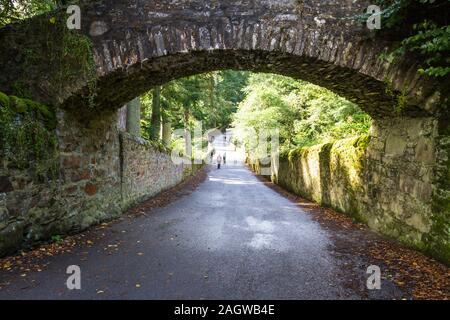 Moss covered stone walls and an arch entering the Blair Castle grounds from the General Wade's Military road in the Scottish Highlands Stock Photo