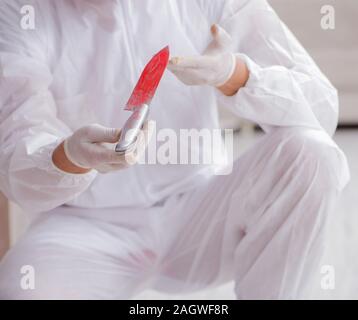 The forensic expert at crime scene doing investigation Stock Photo