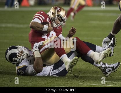 Santa Clara, USA. 21st Dec, 2019. San Francisco 49ers quarterback Jimmy Garoppolo is sacked by Los Angeles Rams defensive tackle Aaron Donald (99) for a five yard loss in the third quarter at Levi's Stadium in Santa Clara, California on Saturday, December 21, 2019. The 49ers defeated the Rams 34-31. Photo by Terry Schmitt/UPI Credit: UPI/Alamy Live News Stock Photo
