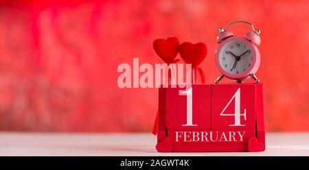 Valentine's day concept. Date '' 14 February '' on wooden red cube calendar. Bokeh red background Stock Photo