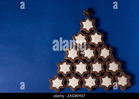 2020 New Year Alternative Christmas trees homemade cookies Christmas-tree decorations-balls lying on a blue background. Close-up, horizontal layout, Stock Photo