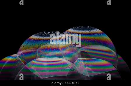 A pile of transparent soap bubbles with an interference pattern on the surface Stock Photo