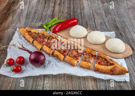 Traditional Turkish dish pita beef - Kusbasili Pide. Turkish Pide with Cube. Stock Photo