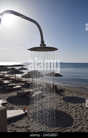 Public shower on the beach. Water jet on the shower standing on the