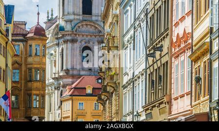 Historic architecture of downtown Prague, Czech Republic. Mostecka Street with St Nicholas Bell Tower. Stock Photo