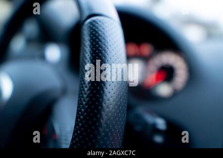 Close up shot of a speedometer in a car. Car dashboard with details with indication lamps and instrument panel. Modern interior Stock Photo