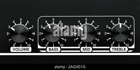 Close up detail of sound volume and equalizer control knobs of a black guitar amplifier Stock Photo