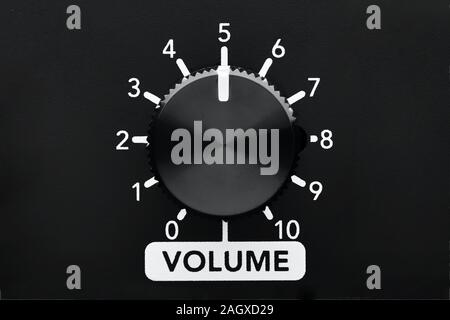 Volume control knob of a black amplifier with dial numbers. Close up view with copy space. Stock Photo