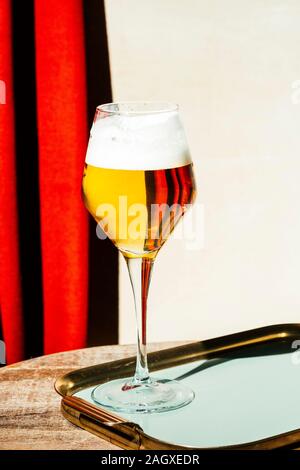 Beer in flute, pils or pilsner, with tortilla chips, light colorful background Stock Photo
