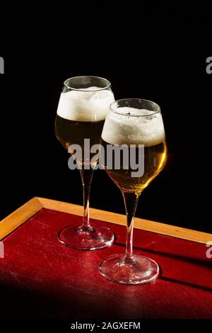 Beer in flute, pils or pilsner, with tortilla chips, light colorful background Stock Photo