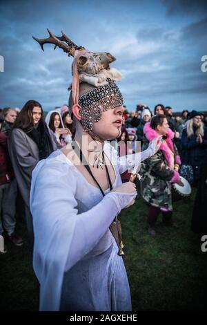 Salisbury, UK. 22nd Dec, 2019. Druids celebrate at sunrise on the shortest day December 22nd 2019. Hundreds of people gathered the famous historic stone circle, in Wiltshire, to celebrate the sunrise on the Winter Solstice the shortest day of the year The event is claimed to be more important in the pagan calendar than the summer solstice because it marks the rebirth of the Sun for the year ahead Credit: David Betteridge/Alamy Live News Stock Photo