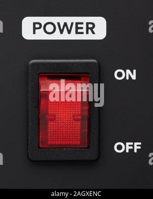 Power on and off electrical switch red button on black background. Close up detail. Stock Photo
