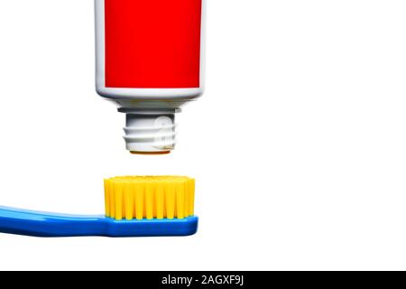 Toothpaste tube ready to squeeze is over the top of a toothbrush against isolated white background. Stock Photo