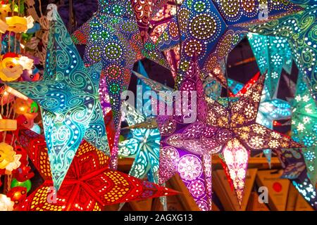 Paper bright multi-colored Christmas and New Year stars decorations Stock Photo