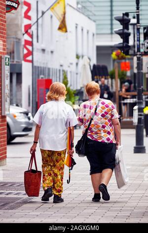 Montreal, Canada - June, 2018: Two Canadian elderly women walking on the street with shopping bags in Montreal, Quebec, Canada. Stock Photo
