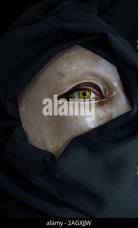 White mask with a green yellow eye Stock Photo