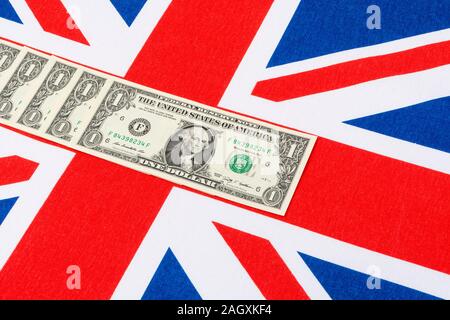 US $1 banknotes / bills & Union Jack. For US Dollar exchange rate concept, US economy, US UK exports, US UK balance of payments, US Holiday money. Stock Photo