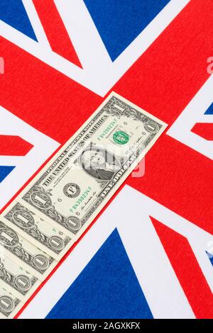 US $1 banknotes / bills & Union Jack. For US Dollar exchange rate concept, US economy, US UK exports, US UK balance of payments, US Holiday money. Stock Photo