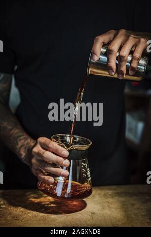 Drip brew coffee pouring in a pot. Stock Photo