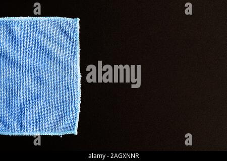 Blue folded microfiber cloth on black table Stock Photo