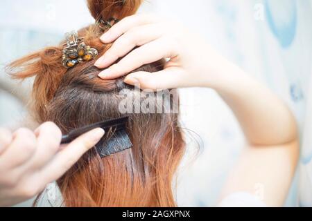 Close up woman combing red hair on white background. Summer day Stock Photo