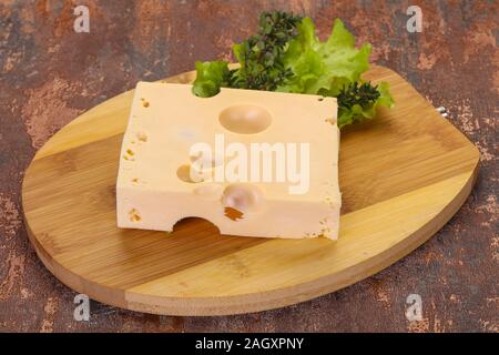 Maasdam cheese brick with thyme branch Stock Photo