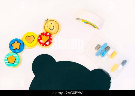 Top view of white tabletop with various drawing tools and toys Stock Photo