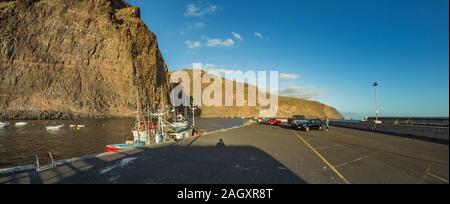 Wide panorama of Playa De Vueltas beach and Port with yacht and fishing boats at the atlantic ocean in La Gomera. A popular vacation spot for tourists Stock Photo