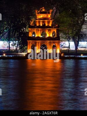 Turtle Tower or Thap Rua lit up at night with reflections in Hoan Kiem Lake, Hanoi, Vietnam, Asia Stock Photo