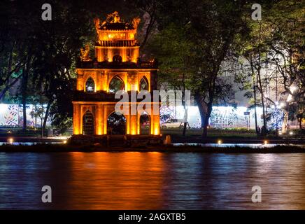 Turtle Tower or Thap Rua lit up at night with reflections in Hoan Kiem Lake, Hanoi, Vietnam, Asia Stock Photo