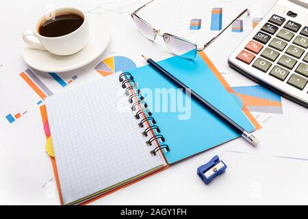 Business and study concept with open notepad, calculator, pencil, coffee and documents Stock Photo