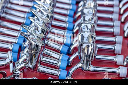 Rows of new faucets in plumbing shop, closeup Stock Photo