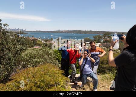 A group of Asian tourists in Australia on holiday posing for a photo near Watson's Bay, Sydney Australia Stock Photo
