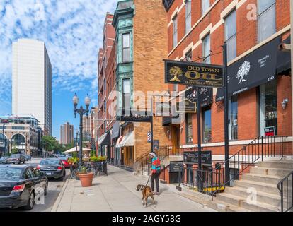 Woman walking a dog on North Wells Street in Old Town, Chicago, Illinois, USA Stock Photo