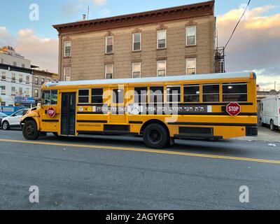 Hebrew lettering on an orthodox private school school bus in Borough Park, an orthodox Jewish neighborhood, in Brooklyn, New York. Stock Photo