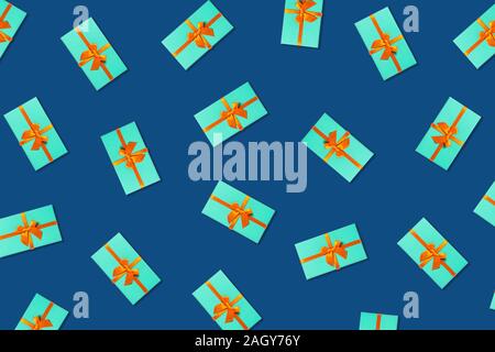 Orange bow on a mint boxes located on classic blue background. Stock Photo