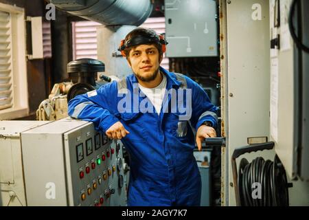 Marine engineer inspecting ship's engine or generators Stock Photo