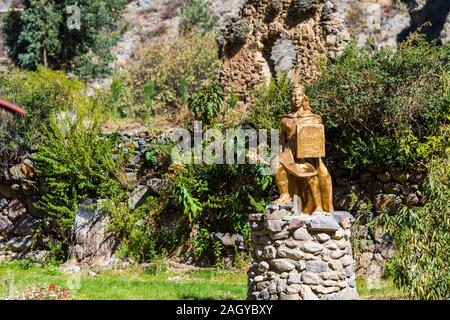 OLLANTAYTAMBO, PERU - JUNE 26, 2019: Golden Inca statue. With selective focus Stock Photo